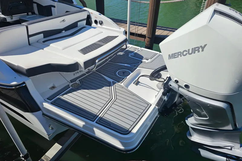 Slide: The Image of 2020 Monterey 275SS Super Sport boat with Mercury engine, docked on water. - 13