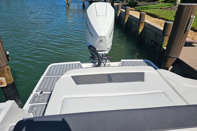 Slide: The Image of 2020 Monterey 275SS Super Sport boat docked, featuring sleek design and powerful outboard motor. - 20