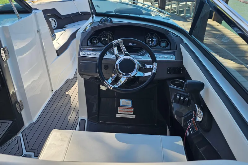 Slide: The Image of 2020 Monterey 275SS Super Sport boat interior with sleek dashboard and steering wheel. - 23