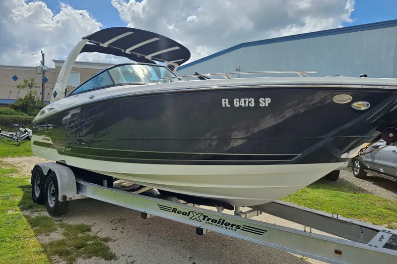 Slide: The Image of 2020 Monterey 275SS Super Sport boat on trailer, parked outdoors under cloudy sky. - 8