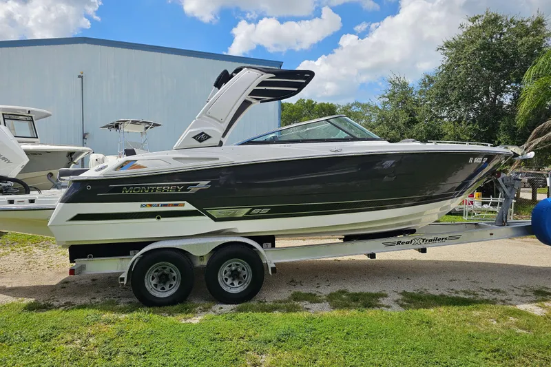 Slide: The Image of 2020 Monterey 275SS Super Sport boat on trailer, parked outdoors under a cloudy sky. - 9