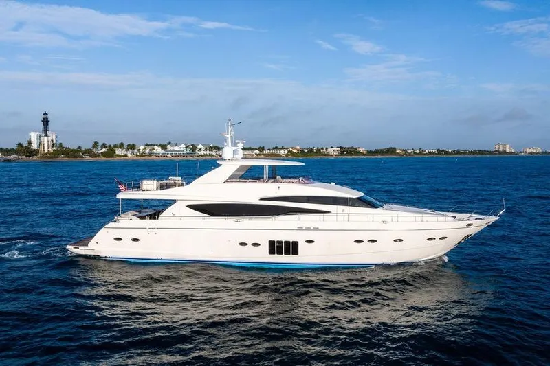 Slide: The Image of 2010 Princess 95 Motor Yacht cruising on blue ocean near coastal buildings. - 1