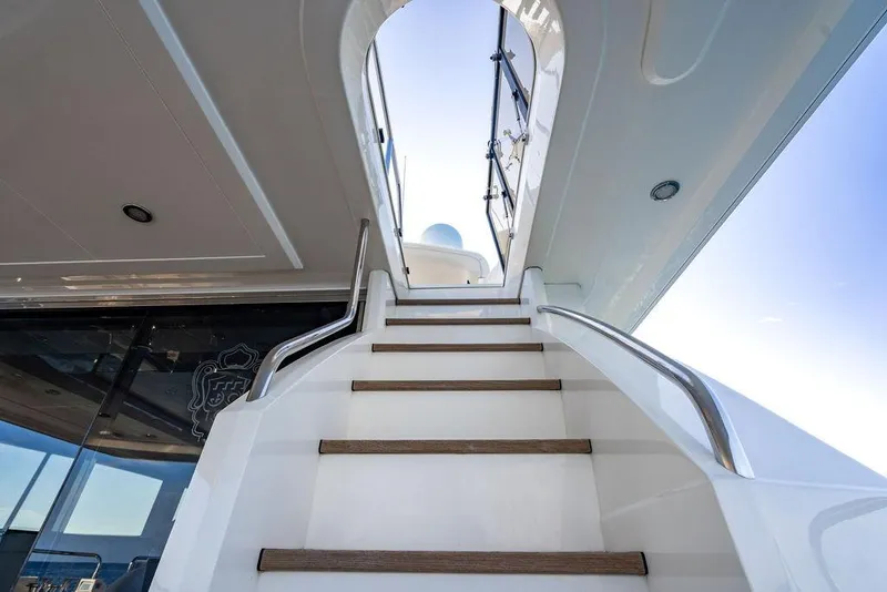 Slide: The Image of Staircase on 2010 Princess 95 Motor Yacht leading to upper deck under clear sky. - 107