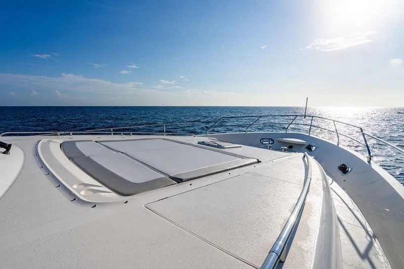 Slide: The Image of 2010 Princess 95 Motor Yacht deck with ocean view under clear blue sky. - 113