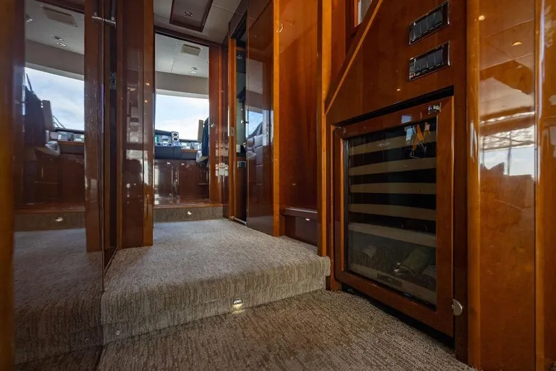 Slide: The Image of Luxurious interior of 2010 Princess 95 Motor Yacht with polished wood and carpeted flooring. - 147