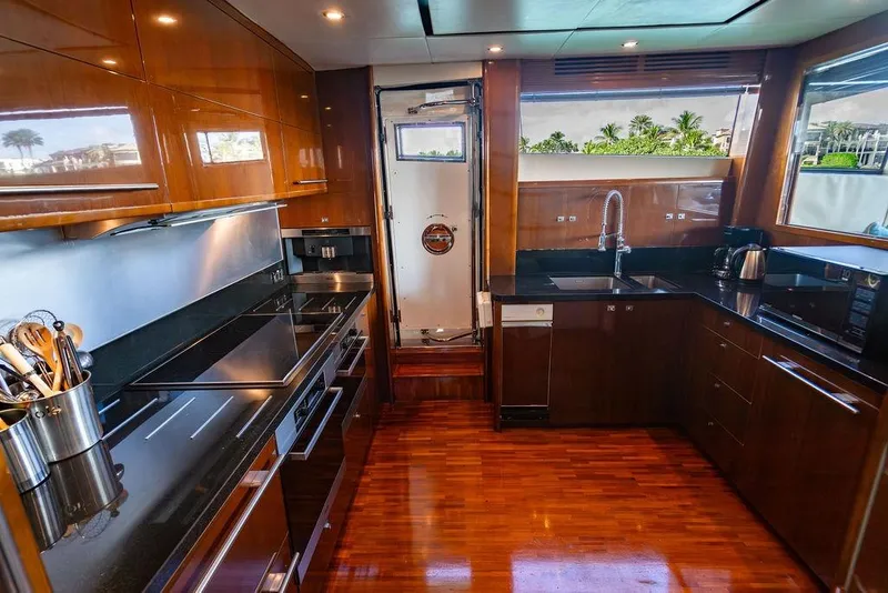Slide: The Image of Luxurious kitchen interior of 2010 Princess 95 Motor Yacht with modern appliances and wood finish. - 150