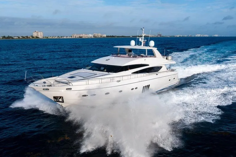 Slide: The Image of 2010 Princess 95 Motor Yacht cruising on open water, creating a dynamic wake. - 42