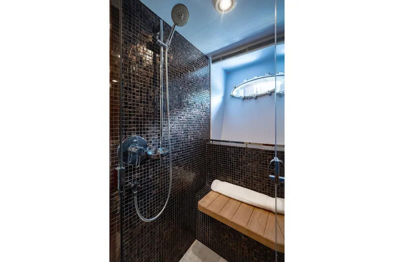 Slide: The Image of Luxurious shower in 2010 Princess 95 Motor Yacht with mosaic tiles and wooden bench. - 66