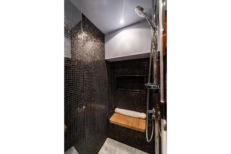 Slide: The Image of Luxurious shower area in 2010 Princess 95 Motor Yacht with modern black tile design. - 75