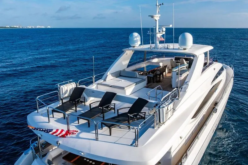 Slide: The Image of Luxurious 2010 Princess 95 Motor Yacht cruising on open sea, featuring spacious deck. - 9