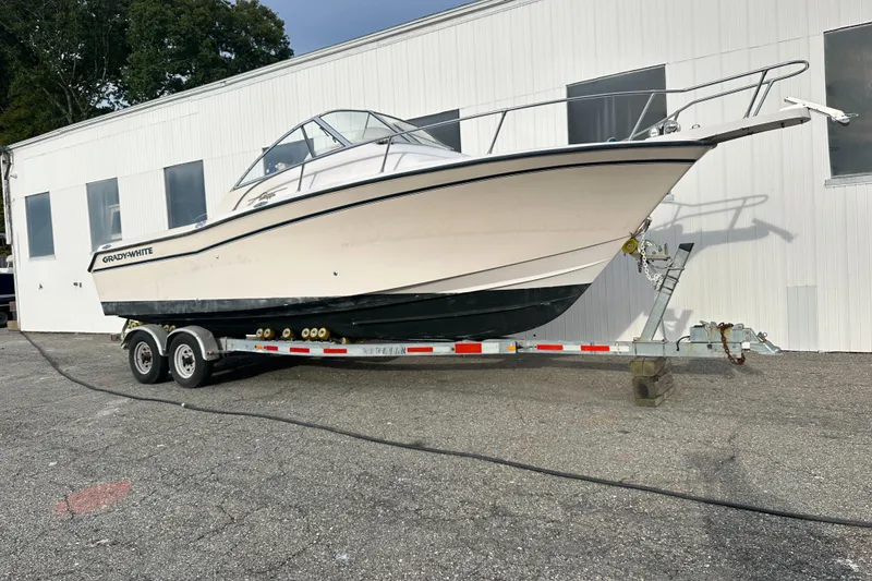 The Image of 2005 Grady-White Express 265 boat on trailer, parked outdoors. - 0