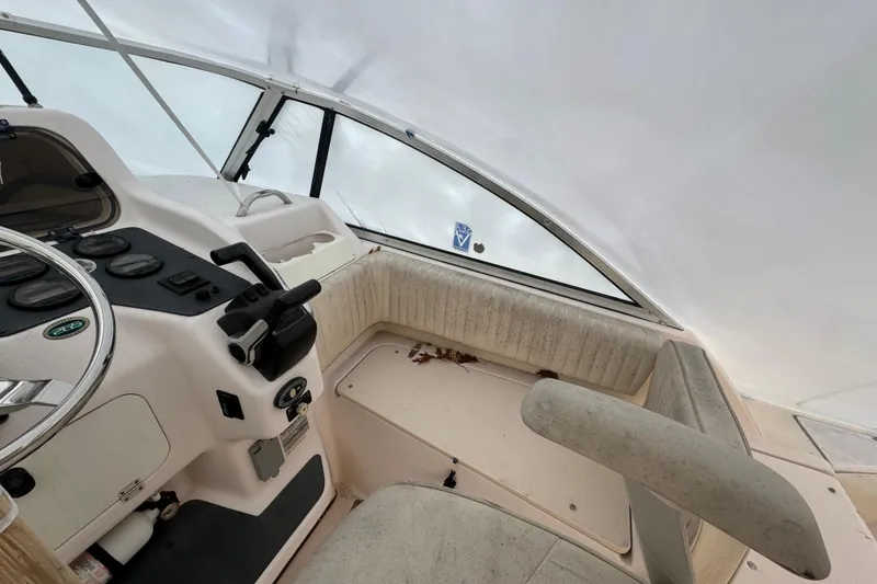Slide: The Image of 2005 Grady-White Express 265 boat interior with steering wheel and control panel. - 12