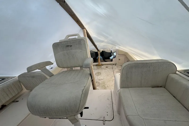 Slide: The Image of 2005 Grady-White Express 265 boat interior with seating under protective cover. - 13