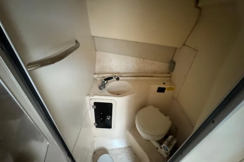 Slide: The Image of 2005 Grady-White Express 265 boat bathroom with sink and toilet. - 19