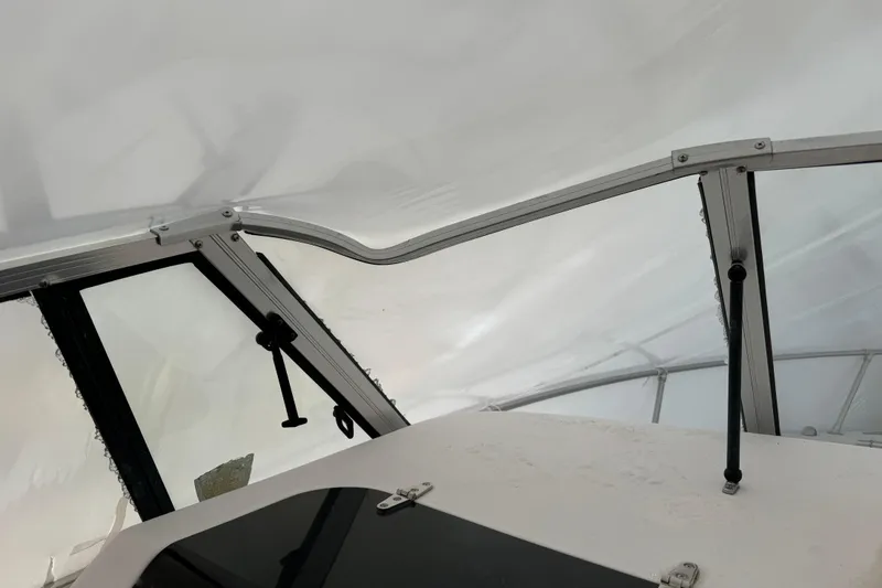 Slide: The Image of Interior view of 2005 Grady-White Express 265 boat, showcasing windshield and cabin roof. - 6