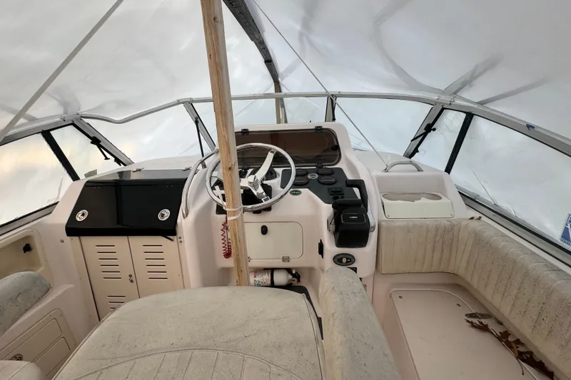 Slide: The Image of 2005 Grady-White Express 265 boat interior with steering wheel and seating area. - 8