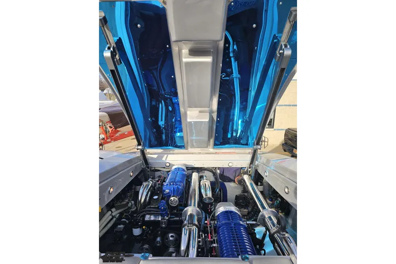 Slide: The Image of Open engine compartment of a 2007 Hustler 41 Razor boat, showcasing detailed components. - 100
