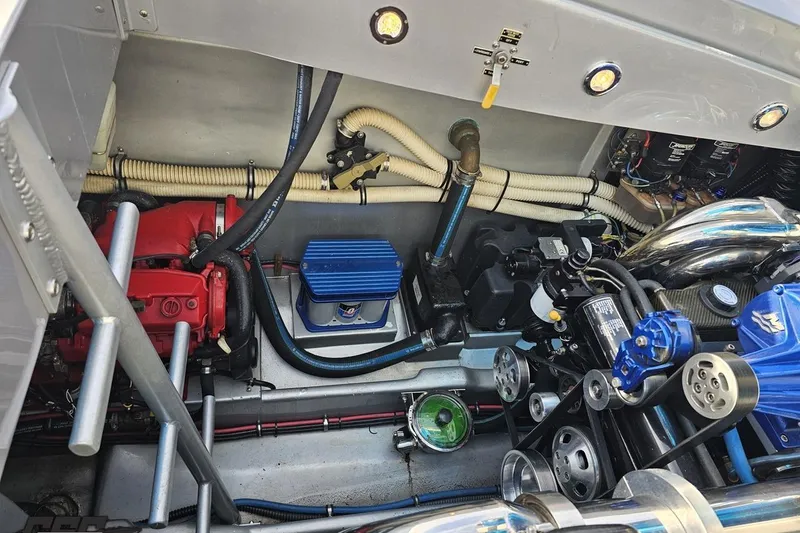 Slide: The Image of Engine compartment of a 2007 Hustler 41 Razor boat, showcasing mechanical components and wiring. - 104