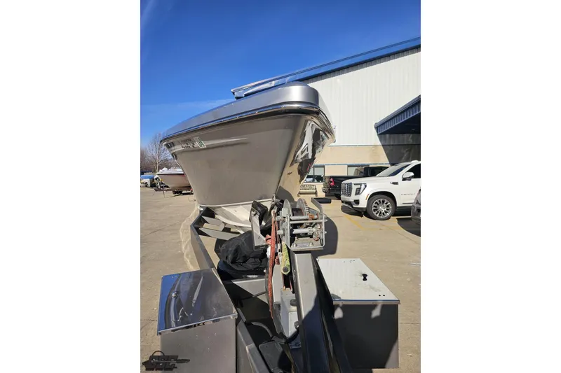 Slide: The Image of 2007 Hustler 41 Razor boat on trailer, parked near a building. - 13