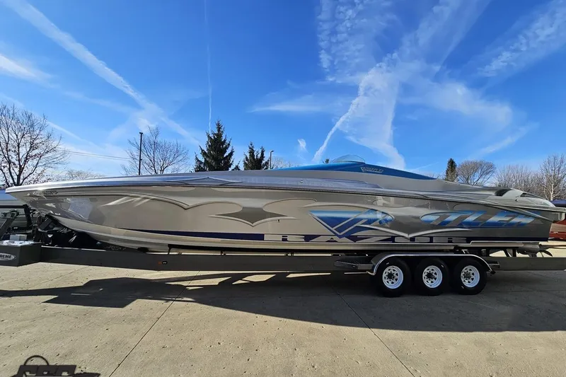 Slide: The Image of 2007 Hustler 41 Razor speedboat on trailer under clear blue sky. - 18