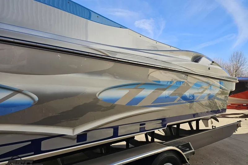 Slide: The Image of 2007 Hustler 41 Razor boat with sleek design and vibrant graphics on trailer. - 21