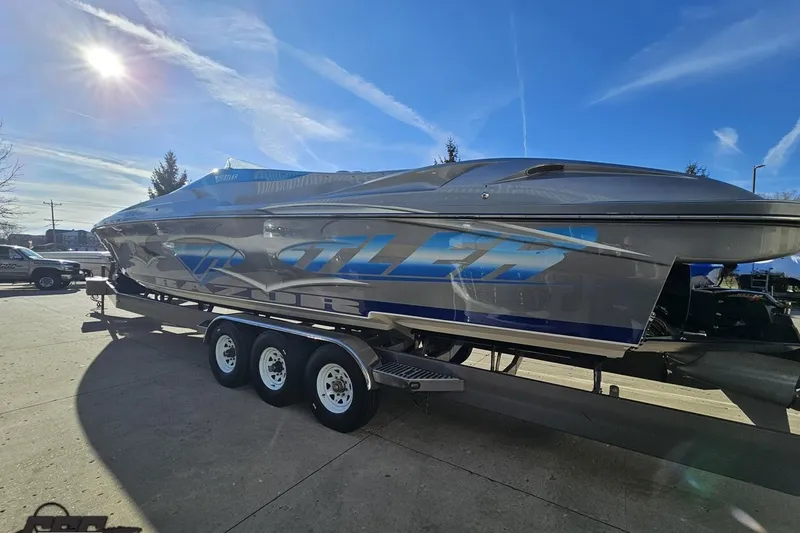 Slide: The Image of 2007 Hustler 41 Razor boat on trailer under clear blue sky. - 24