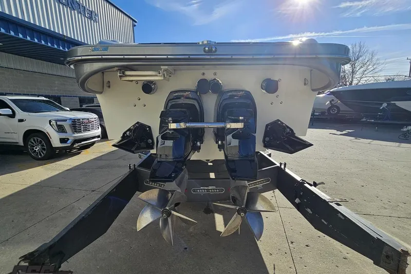 Slide: The Image of 2007 Hustler 41 Razor boat with dual outboard motors in a sunny marina setting. - 28