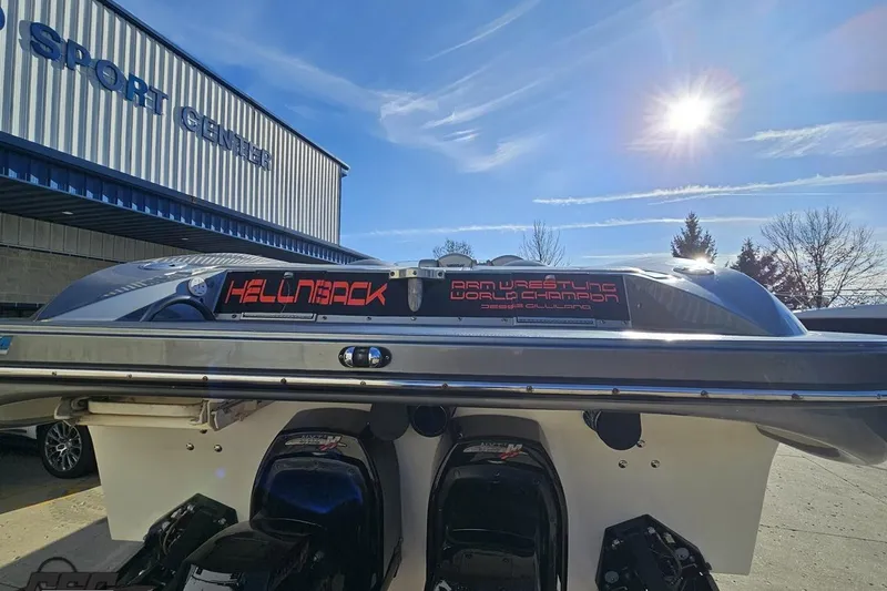 Slide: The Image of 2007 Hustler 41 Razor boat at a sport center under a sunny sky. - 31