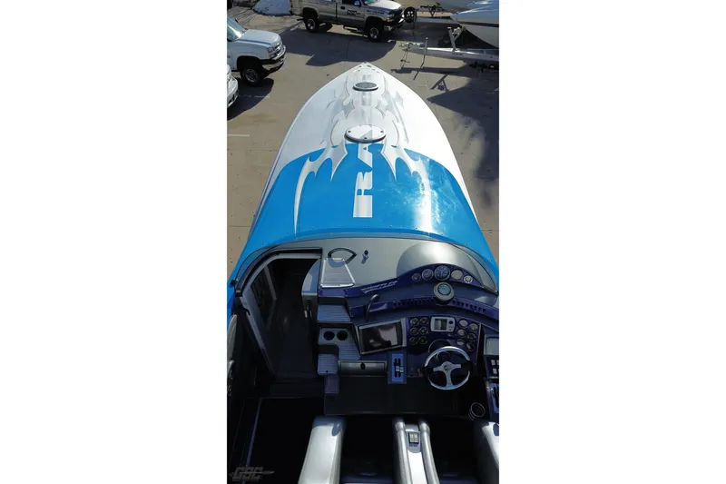 Slide: The Image of 2007 Hustler 41 Razor boat with blue and white design, detailed cockpit view. - 37