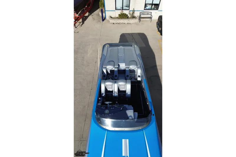 Slide: The Image of 2007 Hustler 41 Razor boat, aerial view, blue and silver design, parked on concrete. - 39