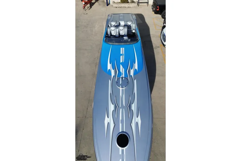 Slide: The Image of 2007 Hustler 41 Razor speedboat with sleek blue and silver flame design. - 42