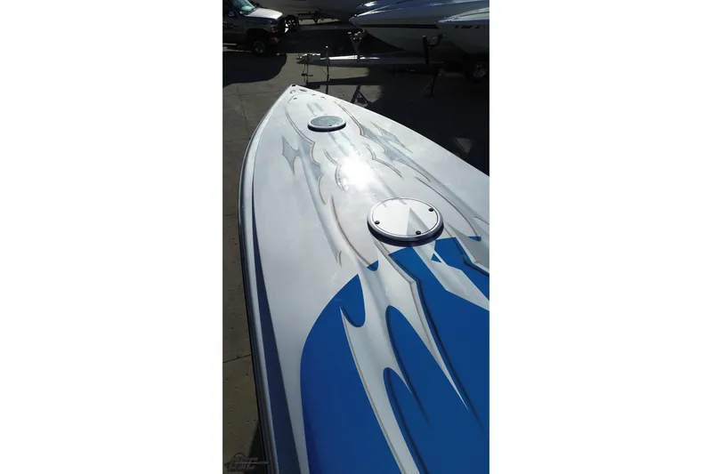 Slide: The Image of 2007 Hustler 41 Razor boat with sleek blue and white design. - 43