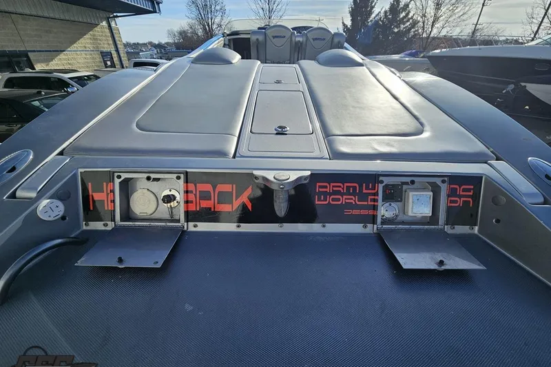 Slide: The Image of 2007 Hustler 41 Razor boat rear view with sleek design and control panels. - 46