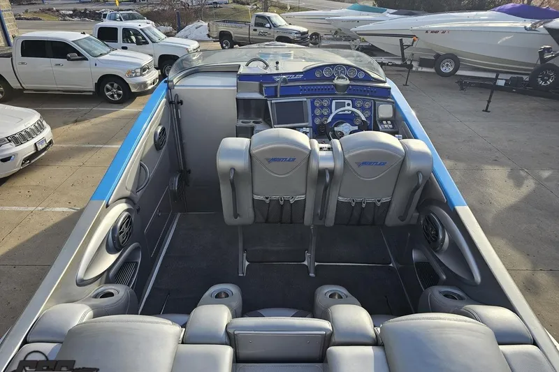 Slide: The Image of 2007 Hustler 41 Razor boat interior with sleek seating and advanced dashboard controls. - 50