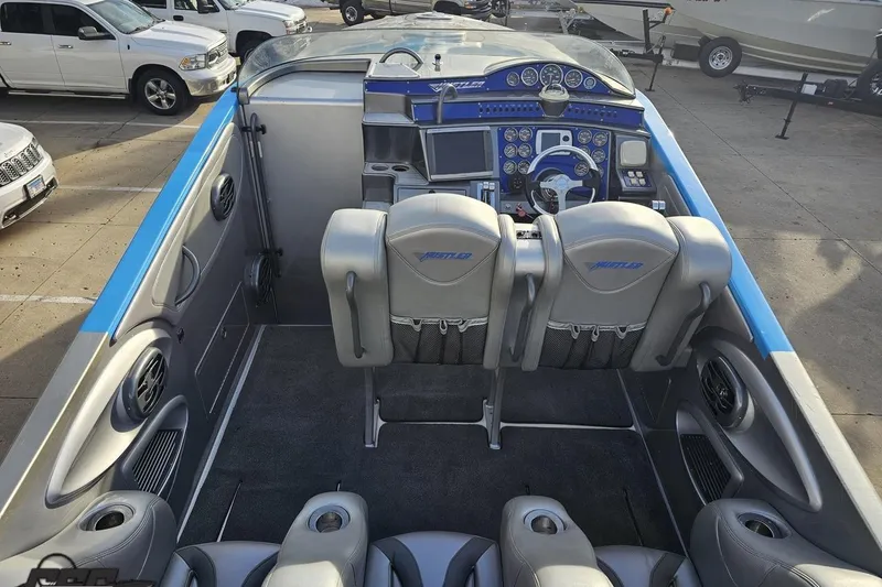 Slide: The Image of 2007 Hustler 41 Razor boat interior with gray seating and advanced dashboard controls. - 51