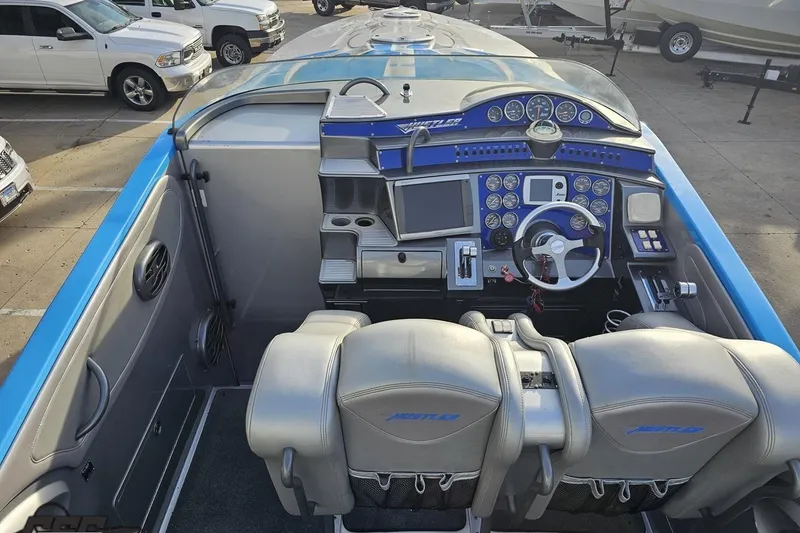 Slide: The Image of 2007 Hustler 41 Razor boat cockpit with advanced controls and dual seating. - 52