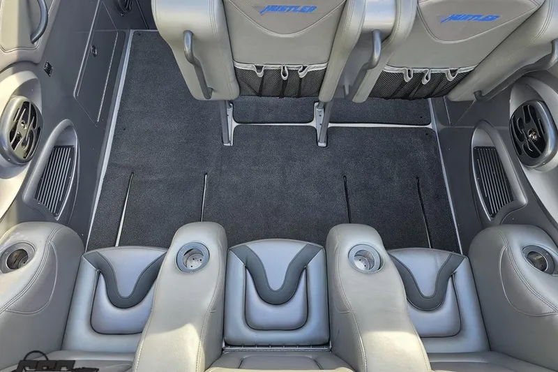 Slide: The Image of Interior of a 2007 Hustler 41 Razor boat with gray seating and cup holders. - 53