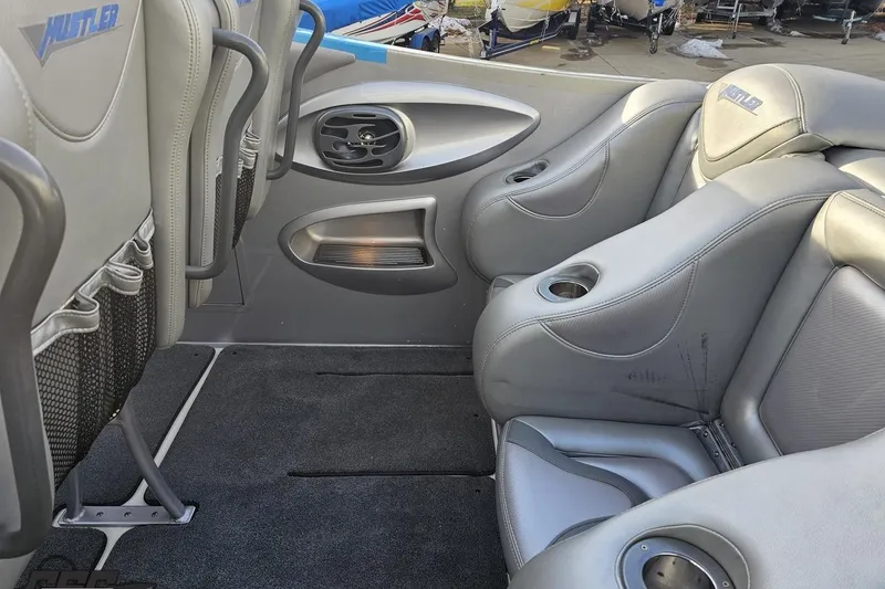 Slide: The Image of Interior of 2007 Hustler 41 Razor boat with gray leather seats and cup holders. - 57