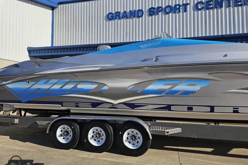 Slide: The Image of 2007 Hustler 41 Razor boat at Grand Sport Center, featuring sleek design and vibrant graphics. - 6