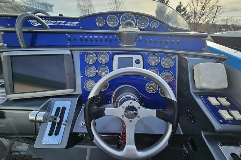 Slide: The Image of Dashboard of a 2007 Hustler 41 Razor boat with steering wheel and gauges. - 61