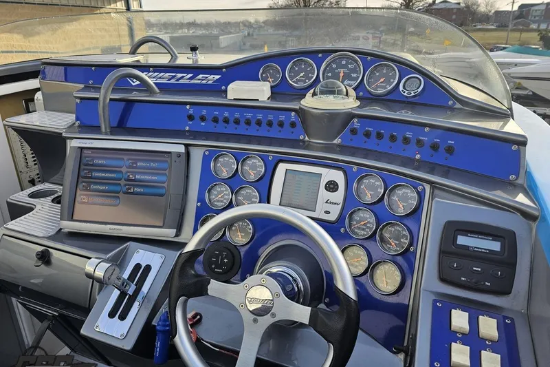 Slide: The Image of Dashboard of a 2007 Hustler 41 Razor boat with gauges and navigation system. - 62