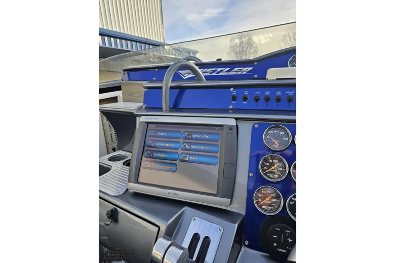 Slide: The Image of Control panel of a 2007 Hustler 41 Razor boat with Garmin navigation system. - 63