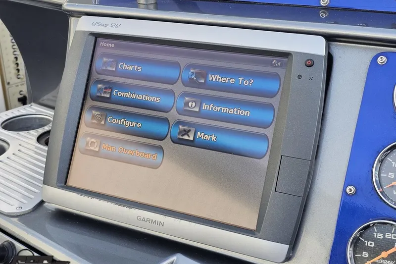 Slide: The Image of Garmin GPSmap 5212 on 2007 Hustler 41 Razor boat dashboard, displaying navigation options. - 64