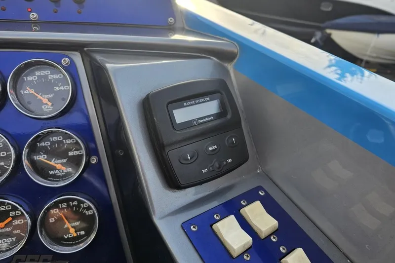 Slide: The Image of Dashboard of a 2007 Hustler 41 Razor boat with gauges and marine intercom. - 68