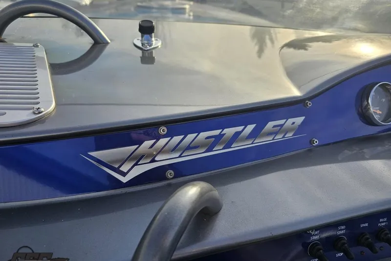 Slide: The Image of 2007 Hustler 41 Razor dashboard with logo and control panel. - 69