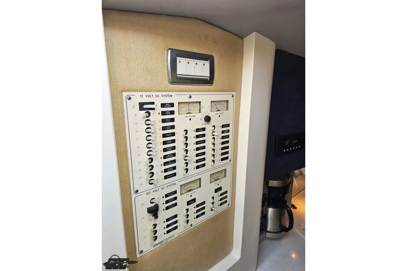 Slide: The Image of Electrical control panel in a 2007 Hustler 41 Razor boat, featuring 12V and 120V systems. - 74