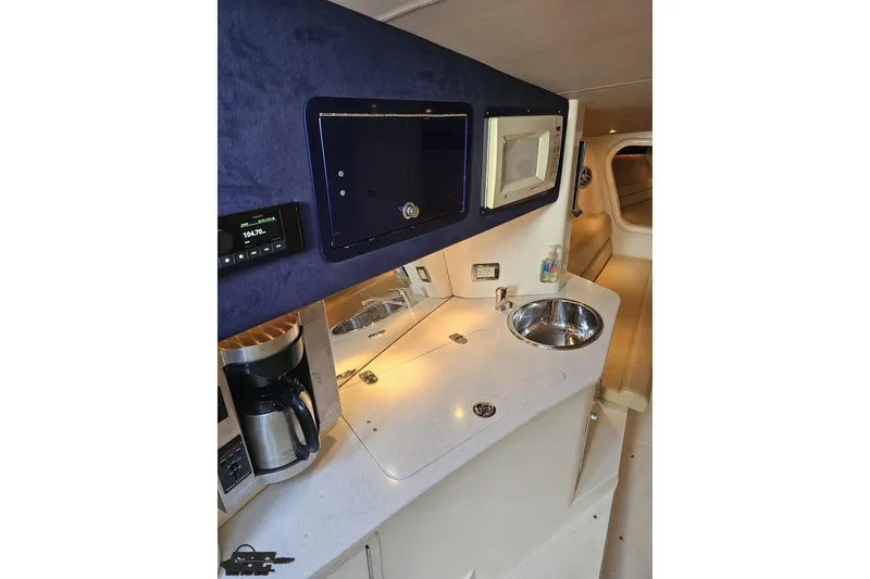 Slide: The Image of Interior of 2007 Hustler 41 Razor boat with kitchenette, sink, and microwave. - 75