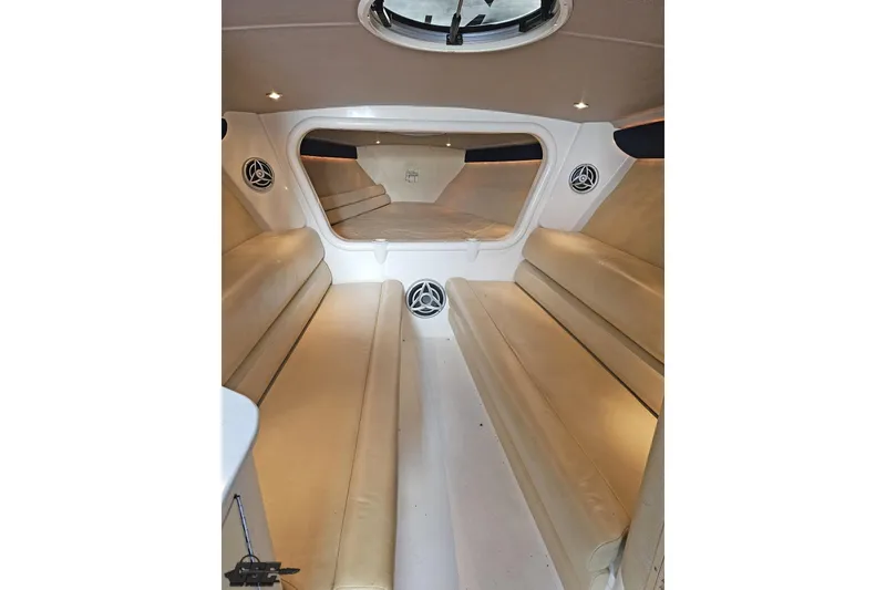 Slide: The Image of Interior of 2007 Hustler 41 Razor boat with beige seating and speakers. - 78