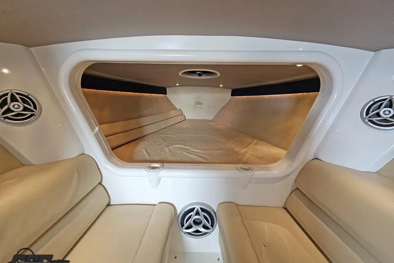 Slide: The Image of Interior of 2007 Hustler 41 Razor boat with beige seating and modern speakers. - 79