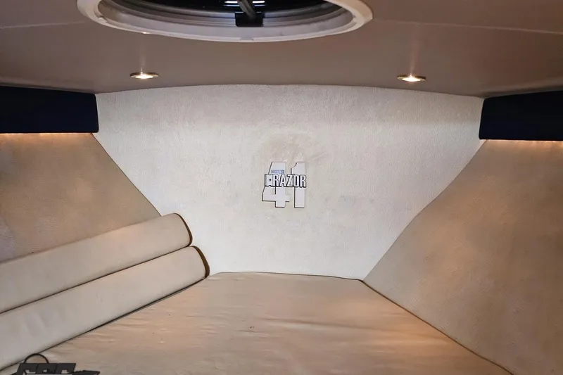 Slide: The Image of Interior cabin of 2007 Hustler 41 Razor boat with logo on wall. - 80